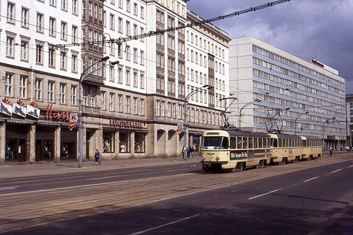 By Felix O (Magdeburg with Konsum Schuh Haus. DDR. May 1990) [CC-BY-SA-2.0 (http://creativecommons.org/licenses/by-sa/2.0)], via Wikimedia Commons