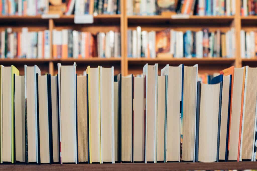 A row of brightly colored books in a library or bookstore.